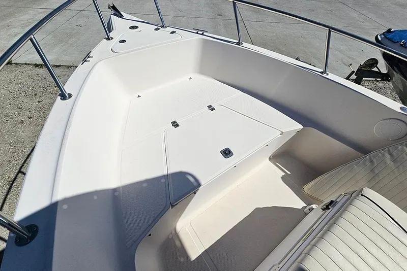 Slide: The Image of Bow area of a 2008 Key West 2020 Center Console boat, featuring seating and storage. - 15