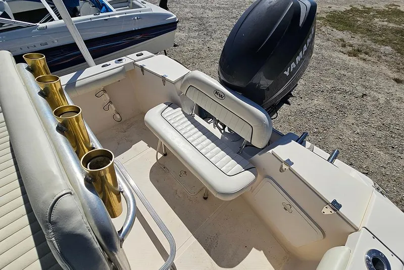 Slide: The Image of Key West 2020 Center Console boat interior with Yamaha engine, featuring seating and rod holders. - 9