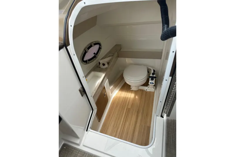 Slide: The Image of 2018 Formula 290 Bowrider boat bathroom interior with toilet and wooden flooring. - 15