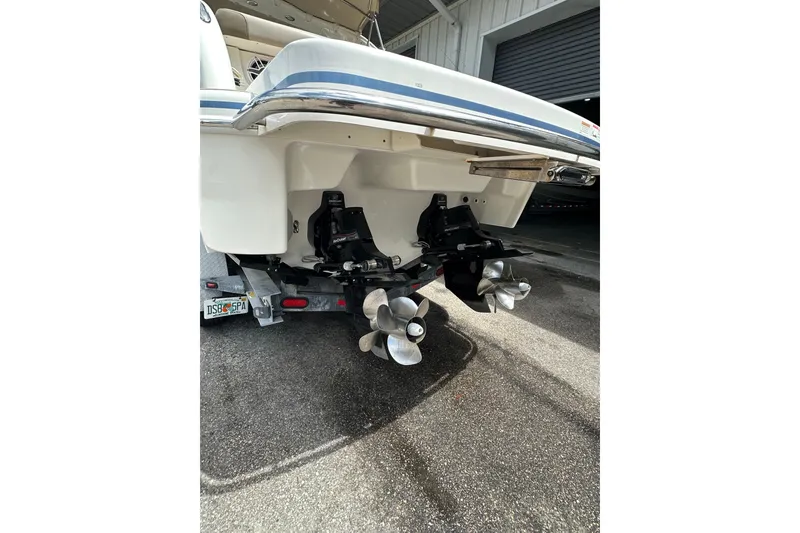 Slide: The Image of 2018 Formula 290 Bowrider boat stern with dual propellers in a garage setting. - 4