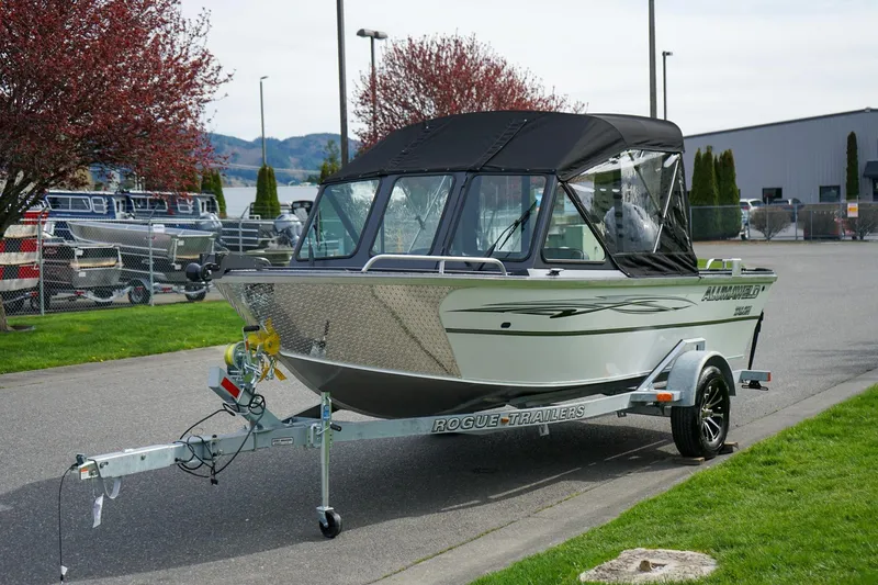 The Image of 2026 Alumaweld Talon 18 boat on trailer, parked outdoors with trees and buildings in background. - 0