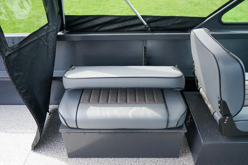 Slide: The Image of 2026 Alumaweld Talon 18 boat interior with gray seating and black accents. - 10
