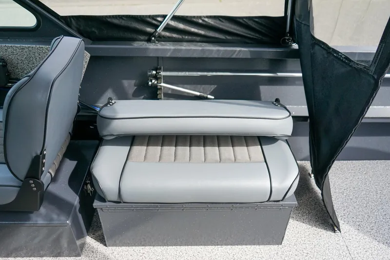 Slide: The Image of 2026 Alumaweld Talon 18 boat interior with gray seating and storage compartment. - 12