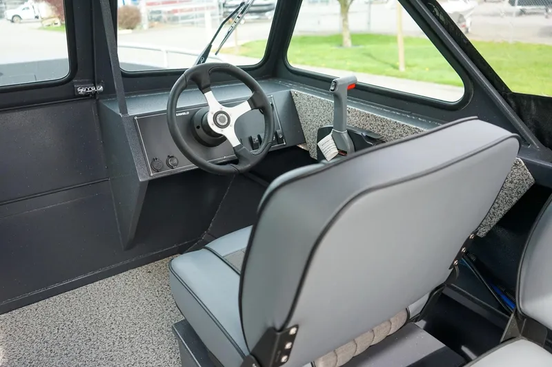 Slide: The Image of Interior of 2026 Alumaweld Talon 18 boat, featuring steering wheel and seating. - 14