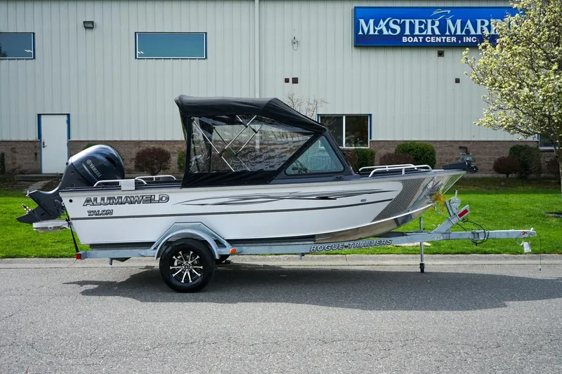 Slide: The Image of 2026 Alumaweld Talon 18 boat on trailer outside Master Marine Boat Center. - 2