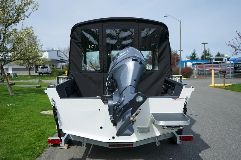 Slide: The Image of 2026 Alumaweld Talon 18 boat with Yamaha outboard motor, parked on a street. - 4