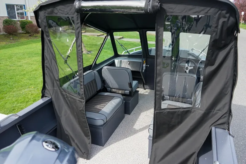 Slide: The Image of 2026 Alumaweld Talon 18 boat interior with seating and protective canopy. - 5