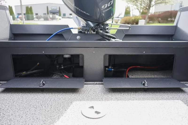 Slide: The Image of 2026 Alumaweld Talon 18 boat storage compartments with visible wiring and Yamaha motor. - 7