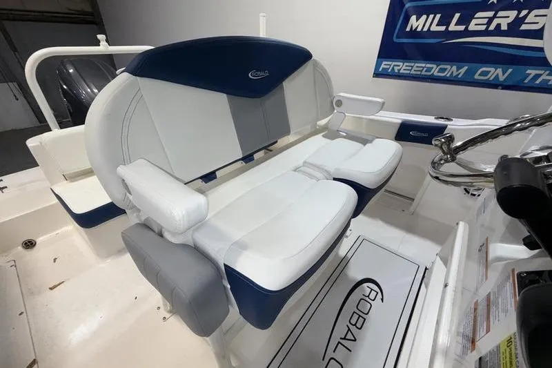 Slide: The Image of 2026 Robalo R222 Explorer boat interior with cushioned seating and steering wheel. - 11