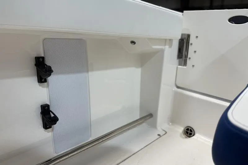 Slide: The Image of Interior view of 2026 Robalo R222 Explorer boat, featuring storage compartment and seating. - 12