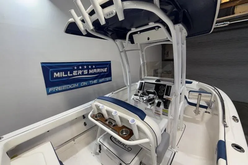 Slide: The Image of 2026 Robalo R222 Explorer boat interior at Miller's Marine showroom. - 14