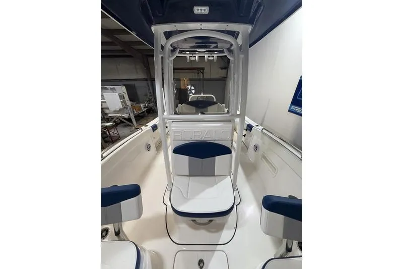 Slide: The Image of 2026 Robalo R222 Explorer boat interior with blue and white seating. - 19