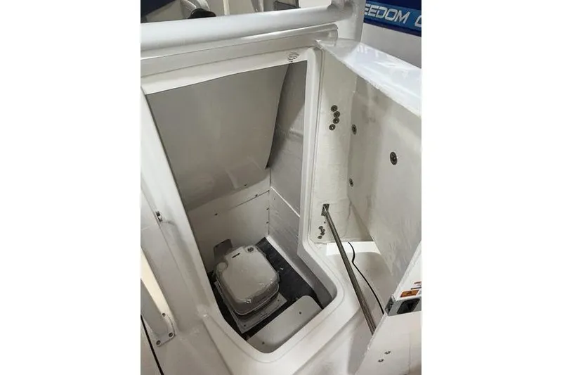 Slide: The Image of 2026 Robalo R222 Explorer boat interior with compact marine toilet. - 20
