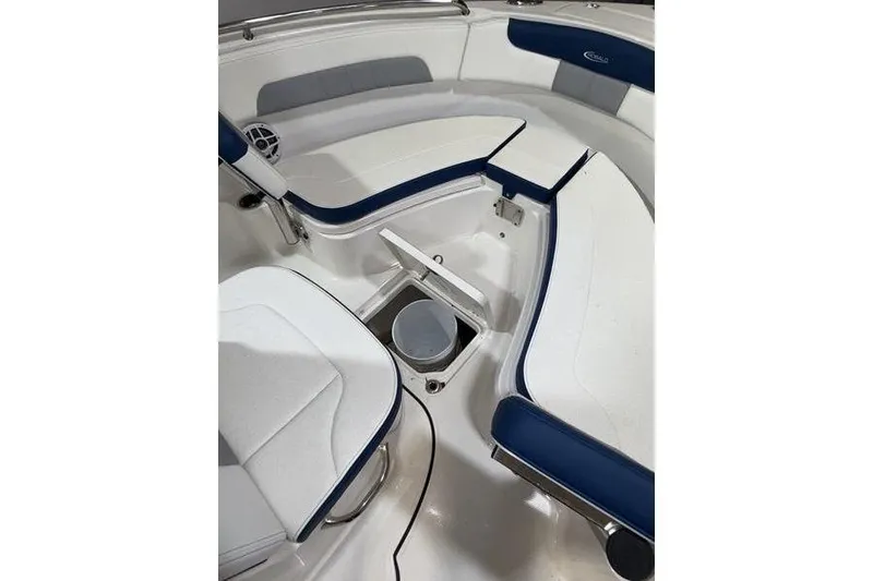 Slide: The Image of 2026 Robalo R222 Explorer boat interior with blue and white seating and storage compartment. - 23