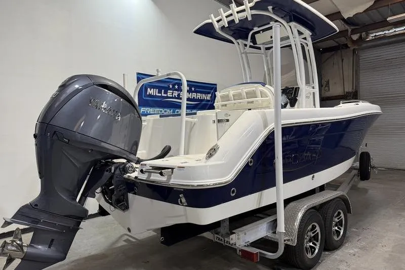Slide: The Image of 2026 Robalo R222 Explorer boat on trailer in indoor showroom. - 3