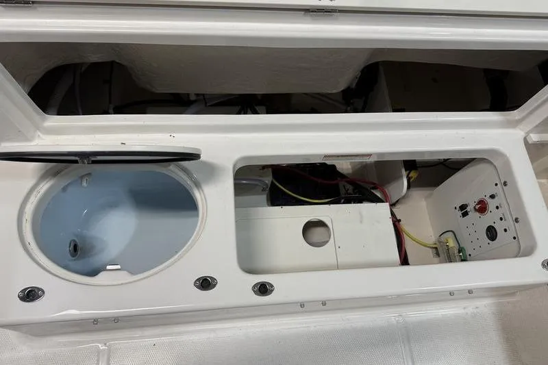 Slide: The Image of 2026 Robalo R222 Explorer boat storage compartment with wiring and livewell. - 9