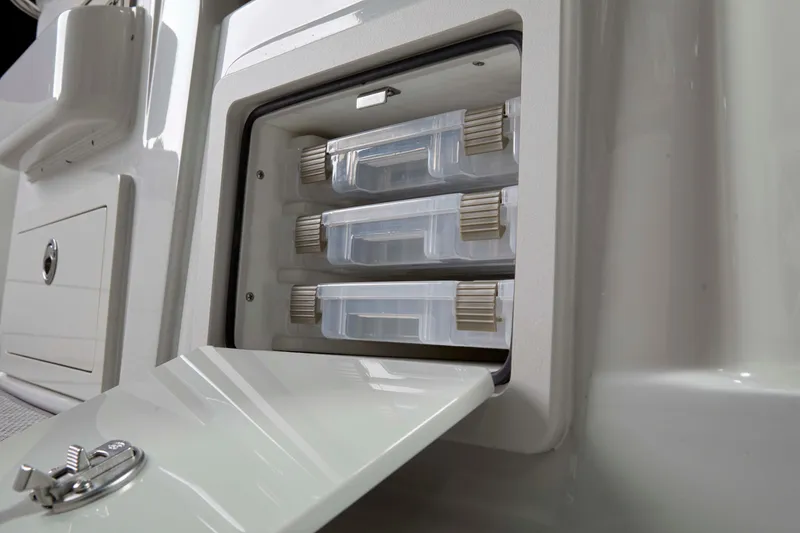 Slide: The Image of Storage compartment with tackle boxes on 2024 Crownline 280 DC Finseeker boat. - 11