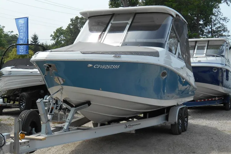Slide: The Image of 2024 Crownline 280 DC Finseeker boat on trailer, displayed outdoors. - 3