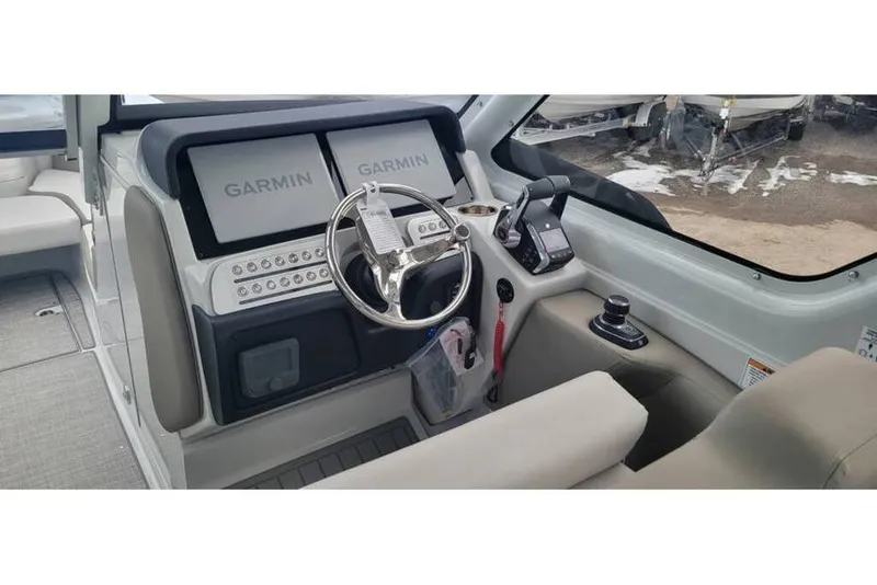 Slide: The Image of 2024 Crownline 280 DC Finseeker helm with dual Garmin displays and modern controls. - 4