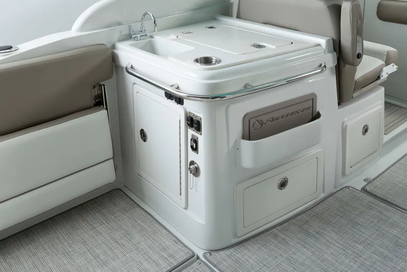 Slide: The Image of 2024 Crownline 280 DC Finseeker boat interior with sink and storage compartments. - 7