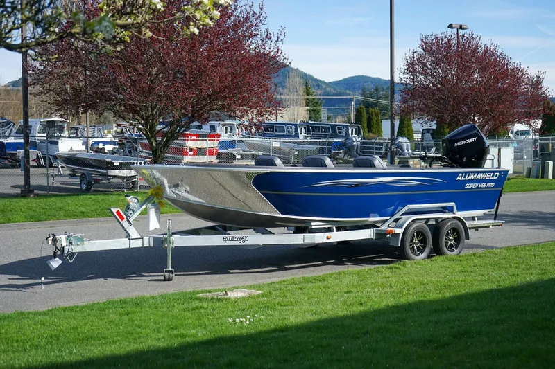 The Image of 2026 Alumaweld Super Vee Pro 21 boat on trailer, parked outdoors. - 1