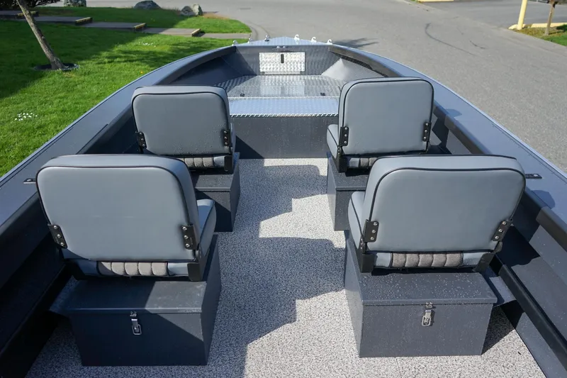 Slide: The Image of 2026 Alumaweld Super Vee Pro 21 boat interior with four gray seats and storage compartments. - 11