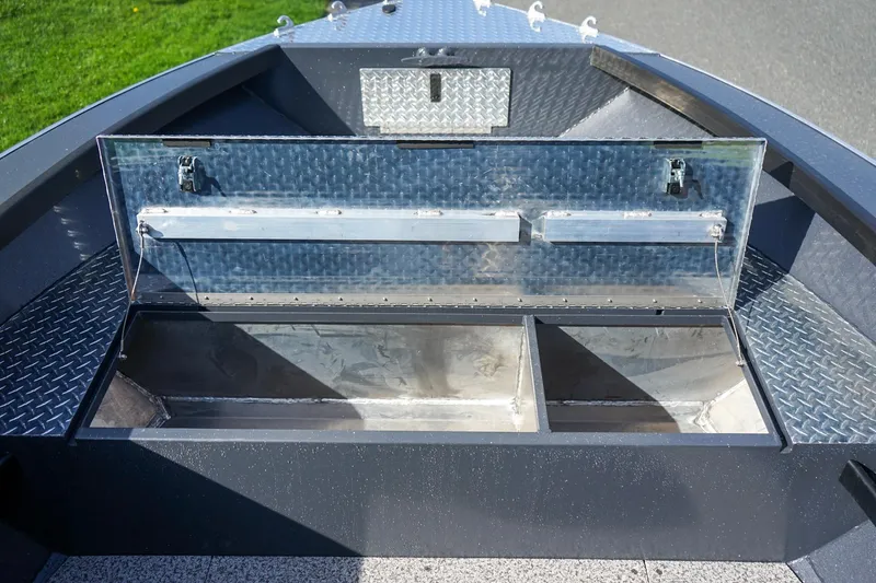 Slide: The Image of 2026 Alumaweld Super Vee Pro 21 boat storage compartment with open hatch, showcasing interior space. - 15