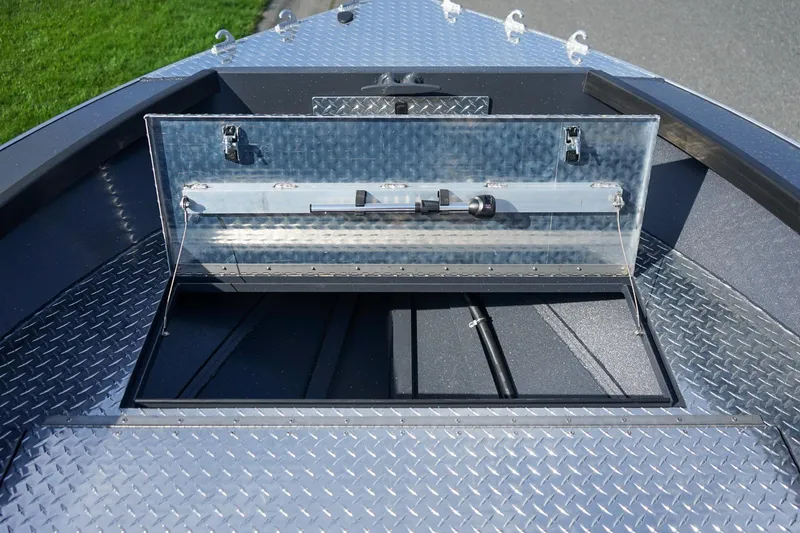 Slide: The Image of 2026 Alumaweld Super Vee Pro 21 boat with open storage compartment and diamond plate flooring. - 16