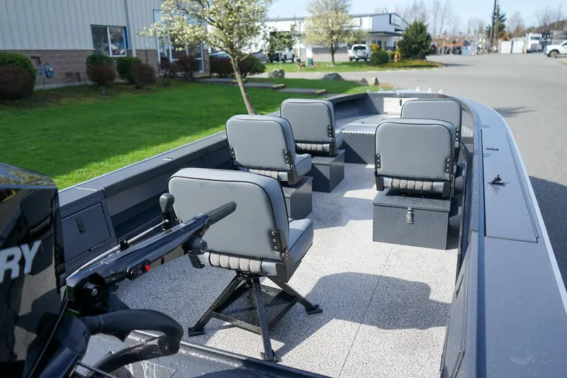 Slide: The Image of 2026 Alumaweld Super Vee Pro 21 boat interior with four gray seats and Mercury motor. - 6