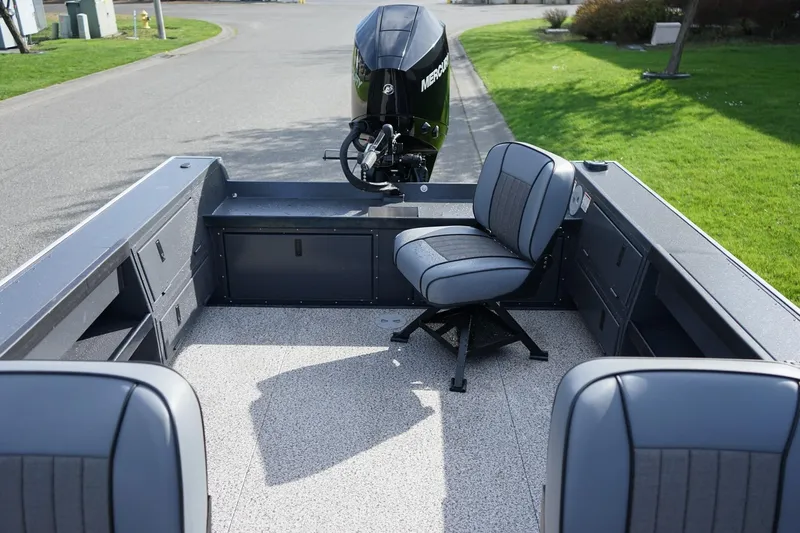 Slide: The Image of 2026 Alumaweld Super Vee Pro 21 boat interior with seating and Mercury outboard motor. - 7