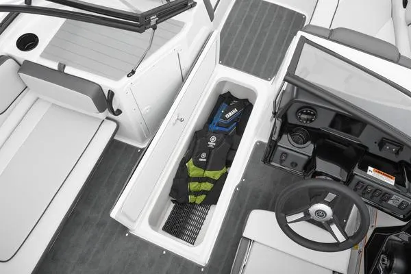 Slide: The Image of 2026 Yamaha Boats SX190 interior with storage compartment and steering wheel. - 6