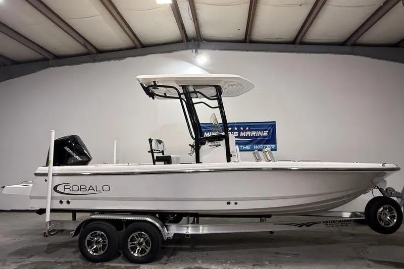 The Image of 2026 Robalo 226 Cayman boat on trailer in indoor showroom. - 0