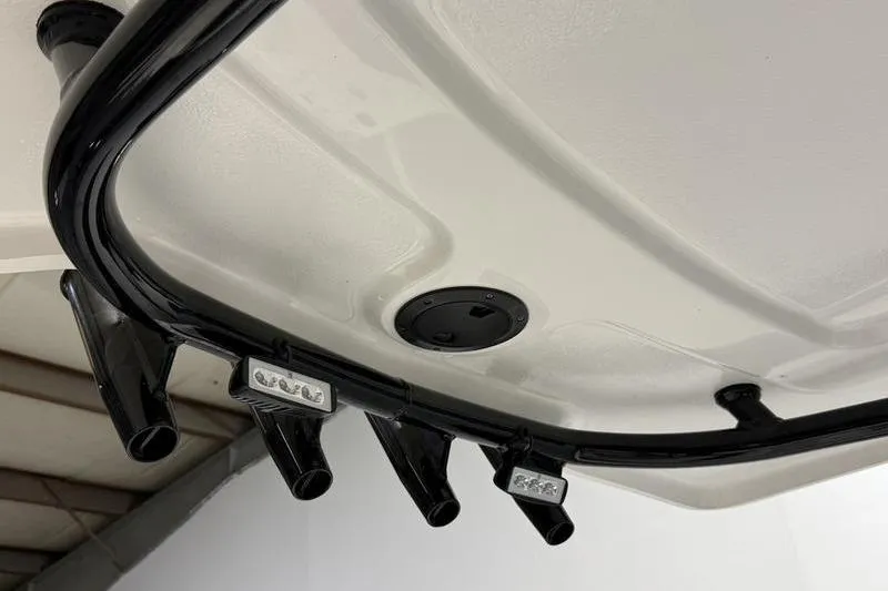 Slide: The Image of 2026 Robalo 226 Cayman boat detail showing rod holders and LED lights. - 10