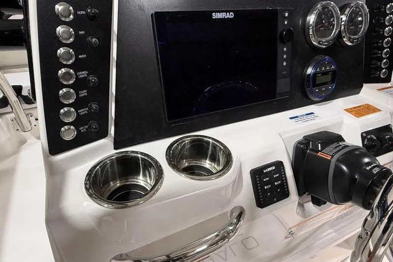 Slide: The Image of Control panel of 2026 Robalo 226 Cayman boat with Simrad display and gauges. - 13