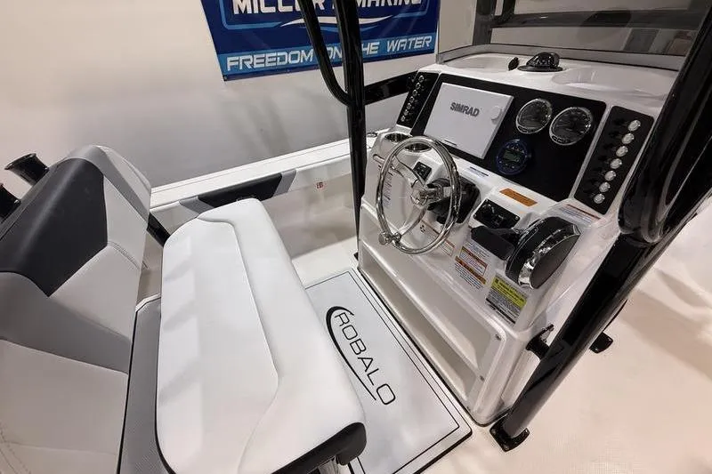 Slide: The Image of 2026 Robalo 226 Cayman boat cockpit with steering wheel and control panel. - 14
