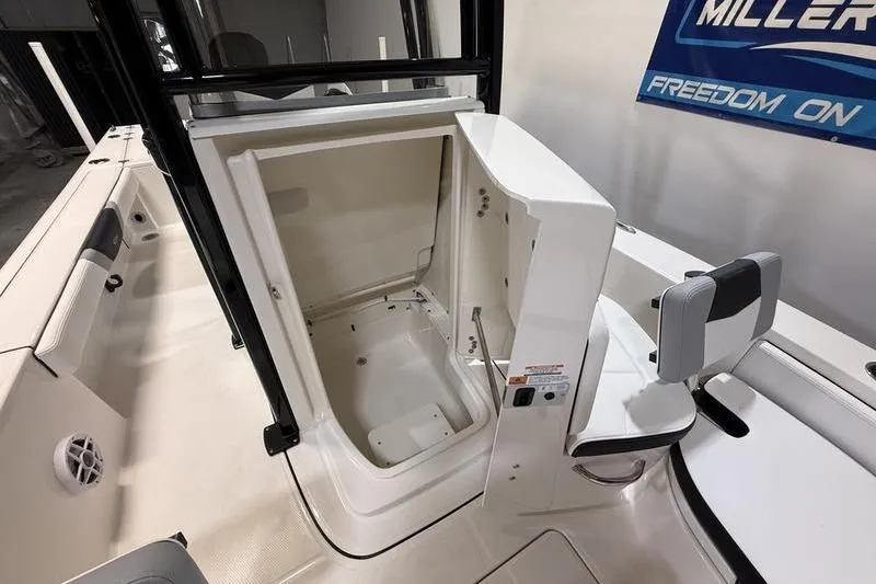 Slide: The Image of 2026 Robalo 226 Cayman boat interior with open storage compartment and seating. - 17