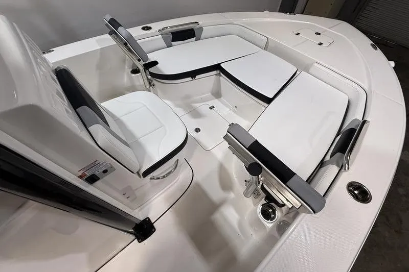 Slide: The Image of 2026 Robalo 226 Cayman boat interior with white seating and sleek design. - 18