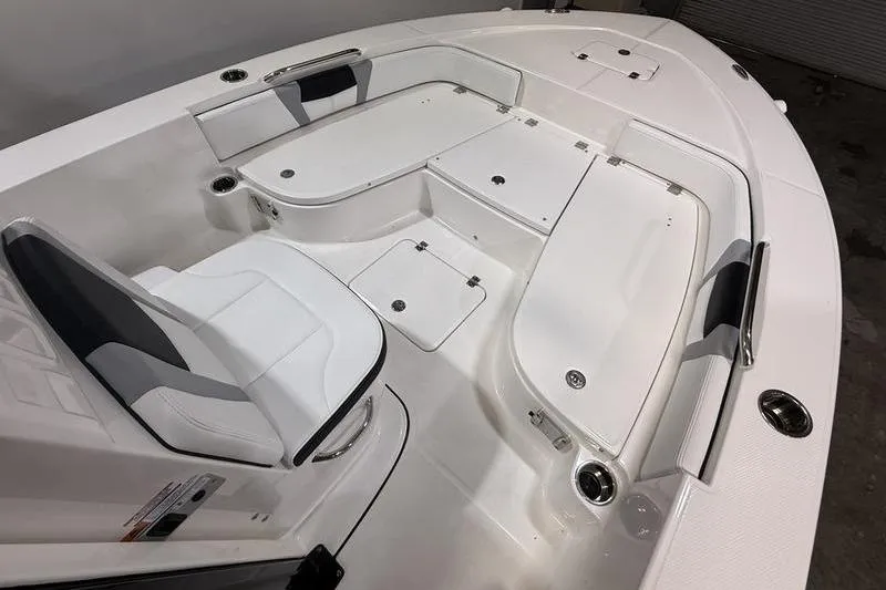 Slide: The Image of 2026 Robalo 226 Cayman boat interior with white seating and storage compartments. - 19