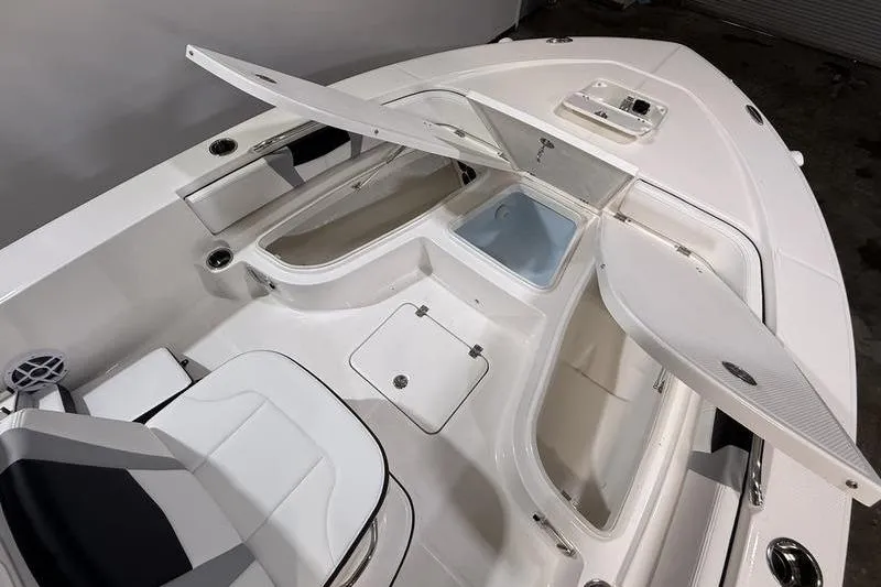 Slide: The Image of 2026 Robalo 226 Cayman boat interior with open storage compartments and seating. - 20