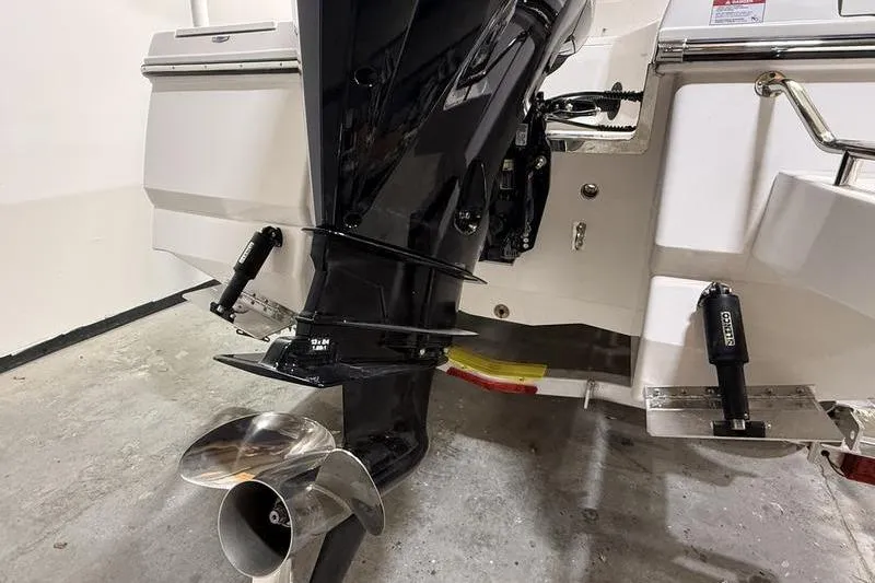 Slide: The Image of 2026 Robalo 226 Cayman boat engine and propeller detail in a garage setting. - 3