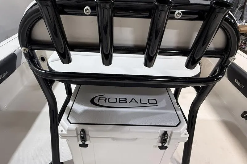 Slide: The Image of 2026 Robalo 226 Cayman boat interior with rod holders and branded cooler. - 4