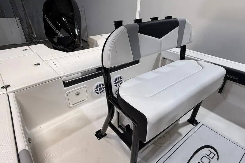 Slide: The Image of 2026 Robalo 226 Cayman boat interior with cushioned seating and Mercury engine. - 5