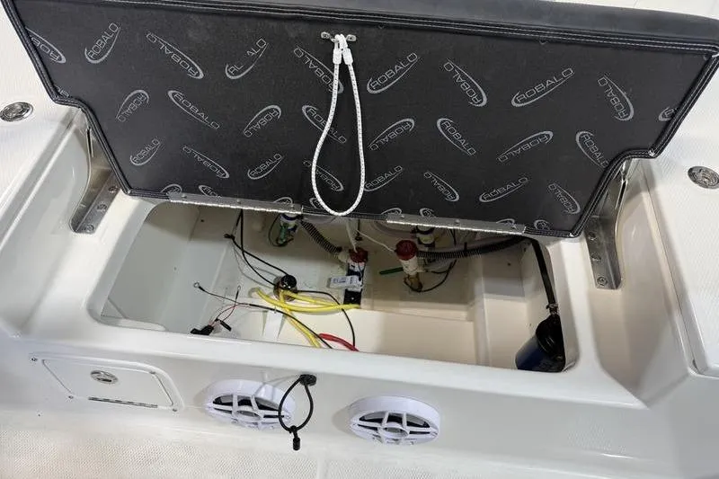Slide: The Image of 2026 Robalo 226 Cayman boat storage compartment with wiring and components visible. - 7