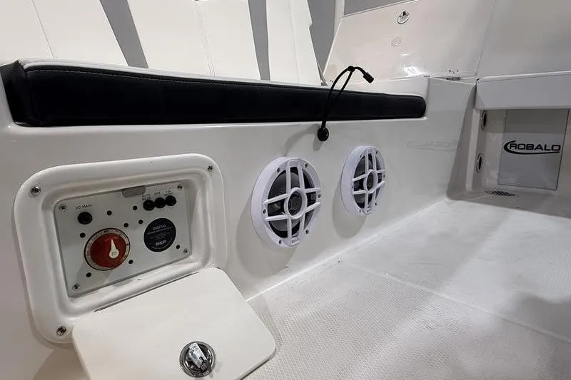 Slide: The Image of Interior of 2026 Robalo 226 Cayman boat featuring speakers and control panel. - 8