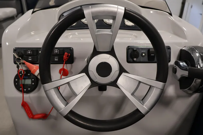 Slide: The Image of Steering wheel of a 2020 Bentley Pontoons 180 CRUISE boat, featuring control panel and ignition keys. - 18