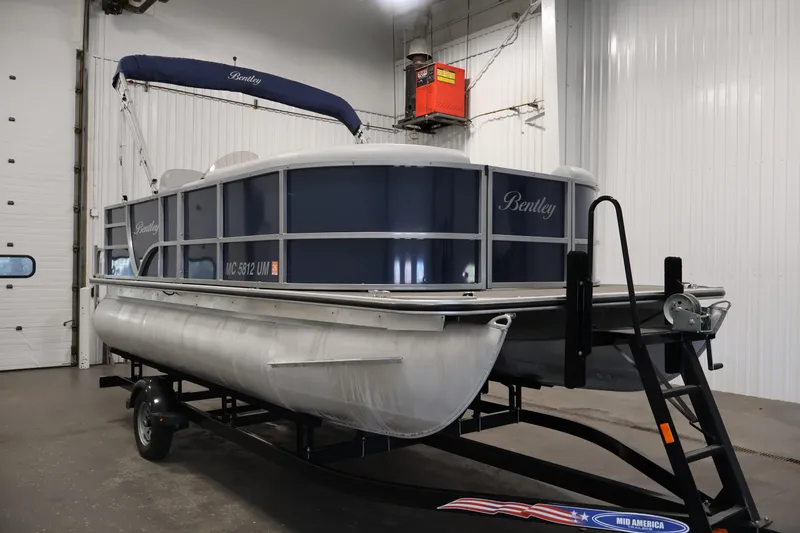 Slide: The Image of 2020 Bentley Pontoons 180 CRUISE pontoon boat in indoor storage facility. - 2