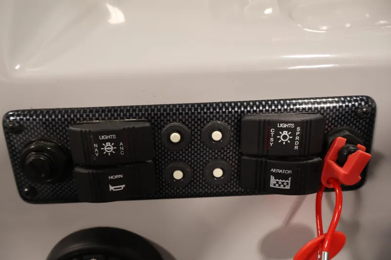 Slide: The Image of Control panel of a 2020 Bentley Pontoons 180 CRUISE with switches and safety lanyard. - 20