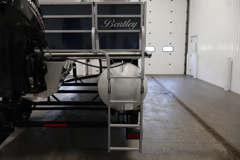 Slide: The Image of 2020 Bentley Pontoons 180 CRUISE in a garage, rear view with ladder and motor. - 30