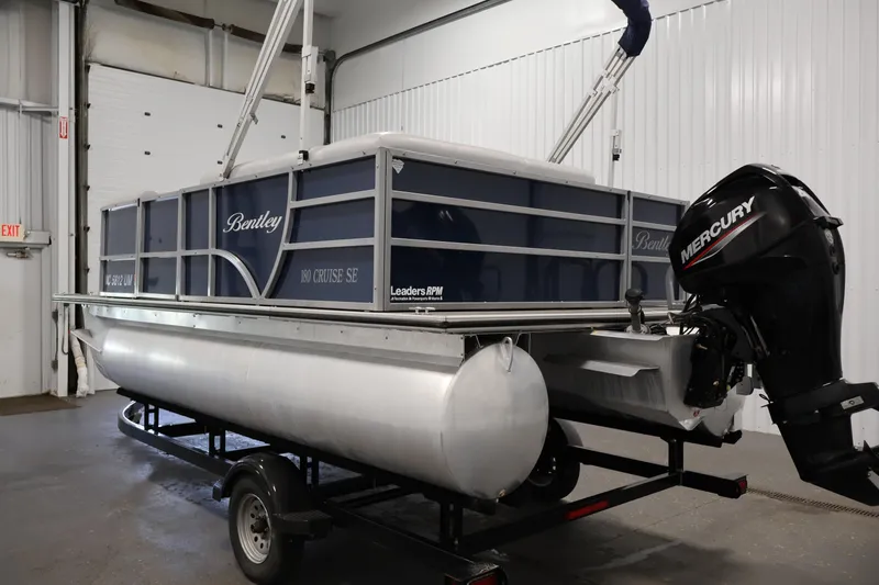 Slide: The Image of 2020 Bentley Pontoons 180 CRUISE boat with Mercury engine in a garage setting. - 6