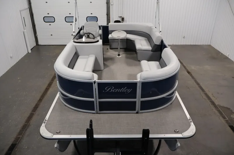 Slide: The Image of 2020 Bentley Pontoons 180 CRUISE in a garage, featuring spacious seating and sleek design. - 8